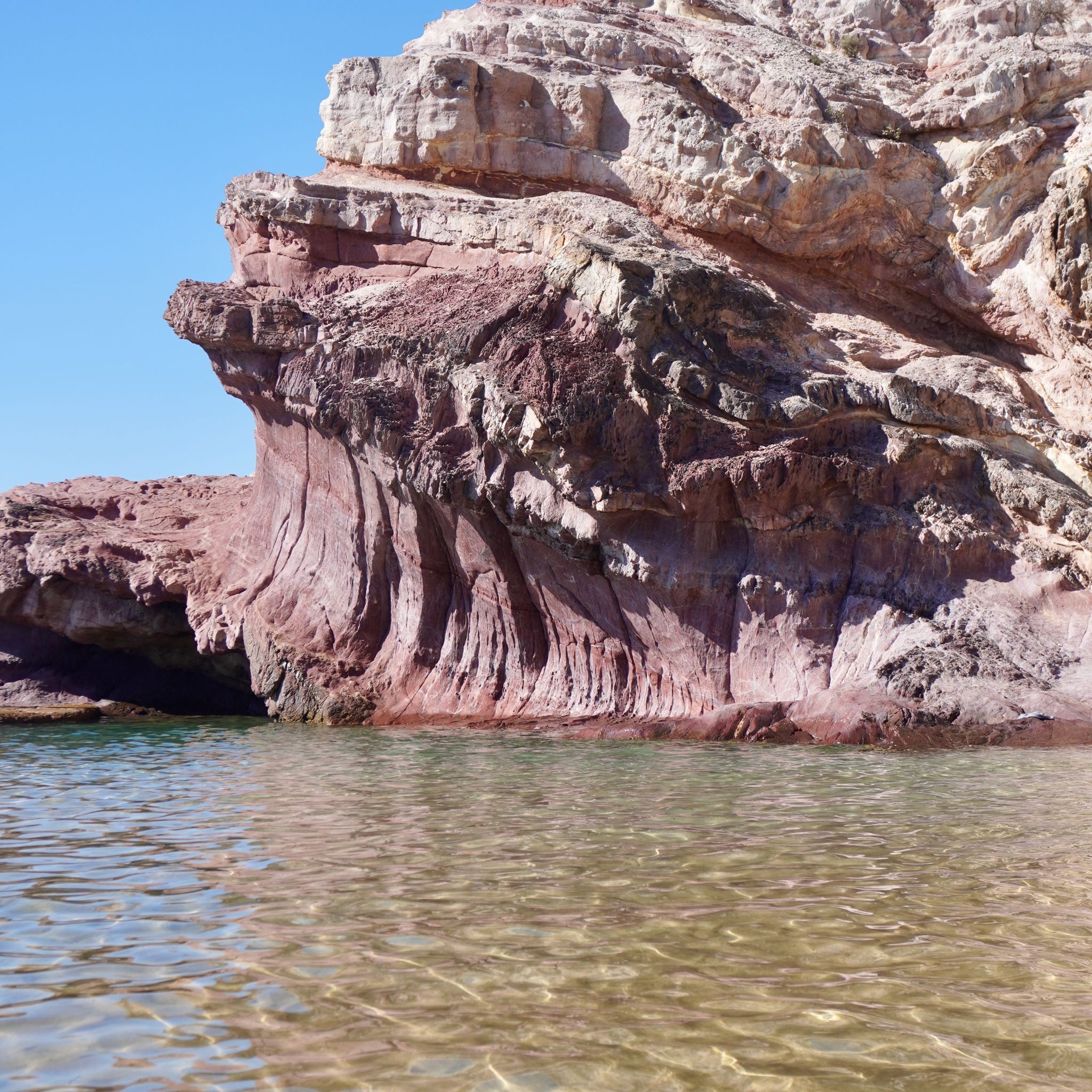 Eden's pool on the south coast of New South Wales, with the pink cliffs in the background and the water in the foreground.