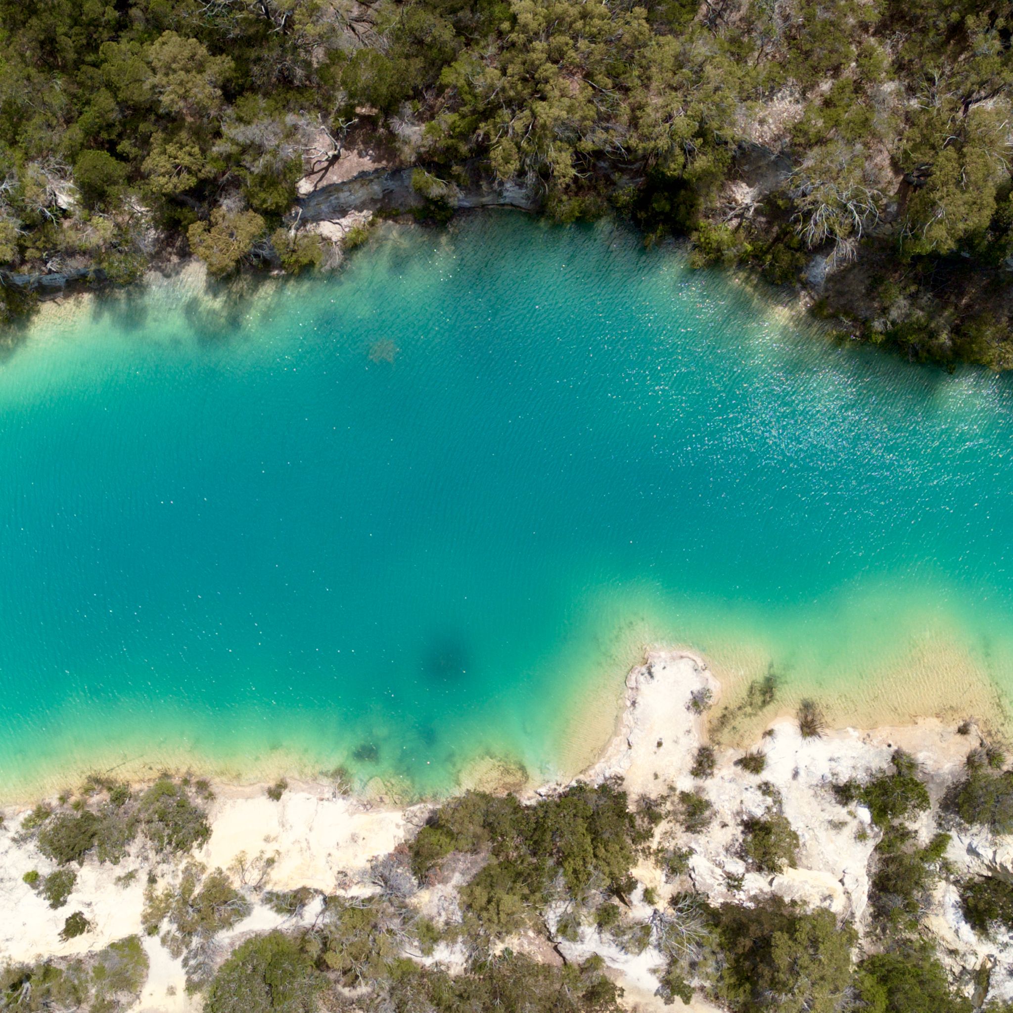 The turquoise waters of the Little Blue Lake photographed from above via a drone.