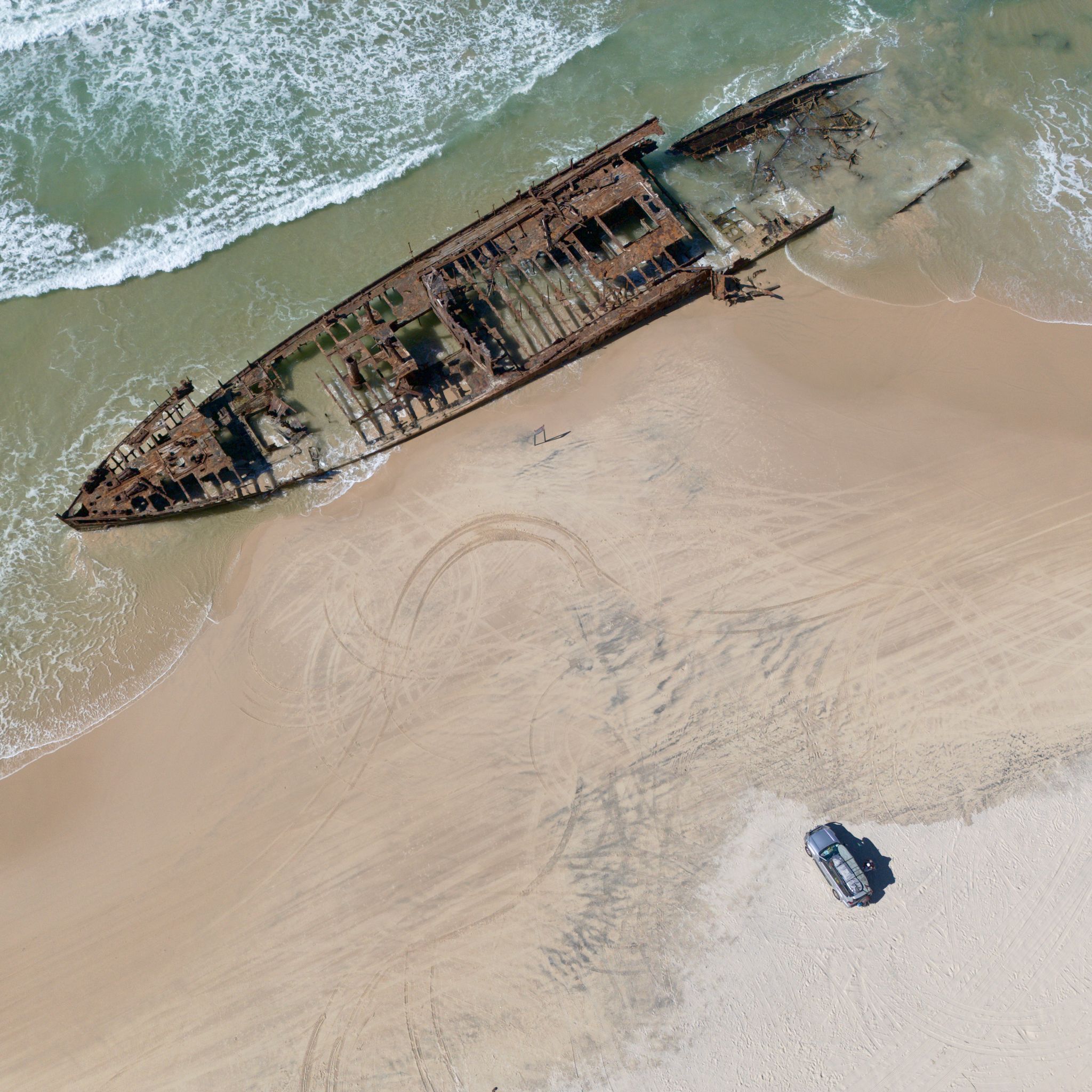 A picture taken with a drone of our car next to the SS Maheno shipwreck on K'Gari.