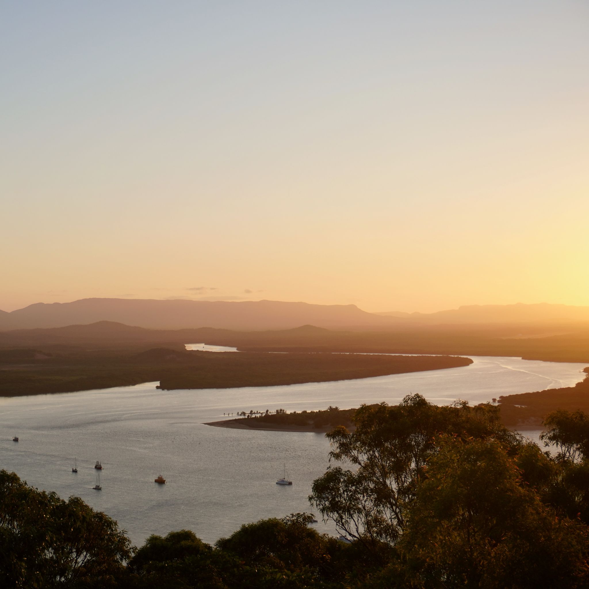 The sun sets over the Endeavour River as seen from Mount Cook.