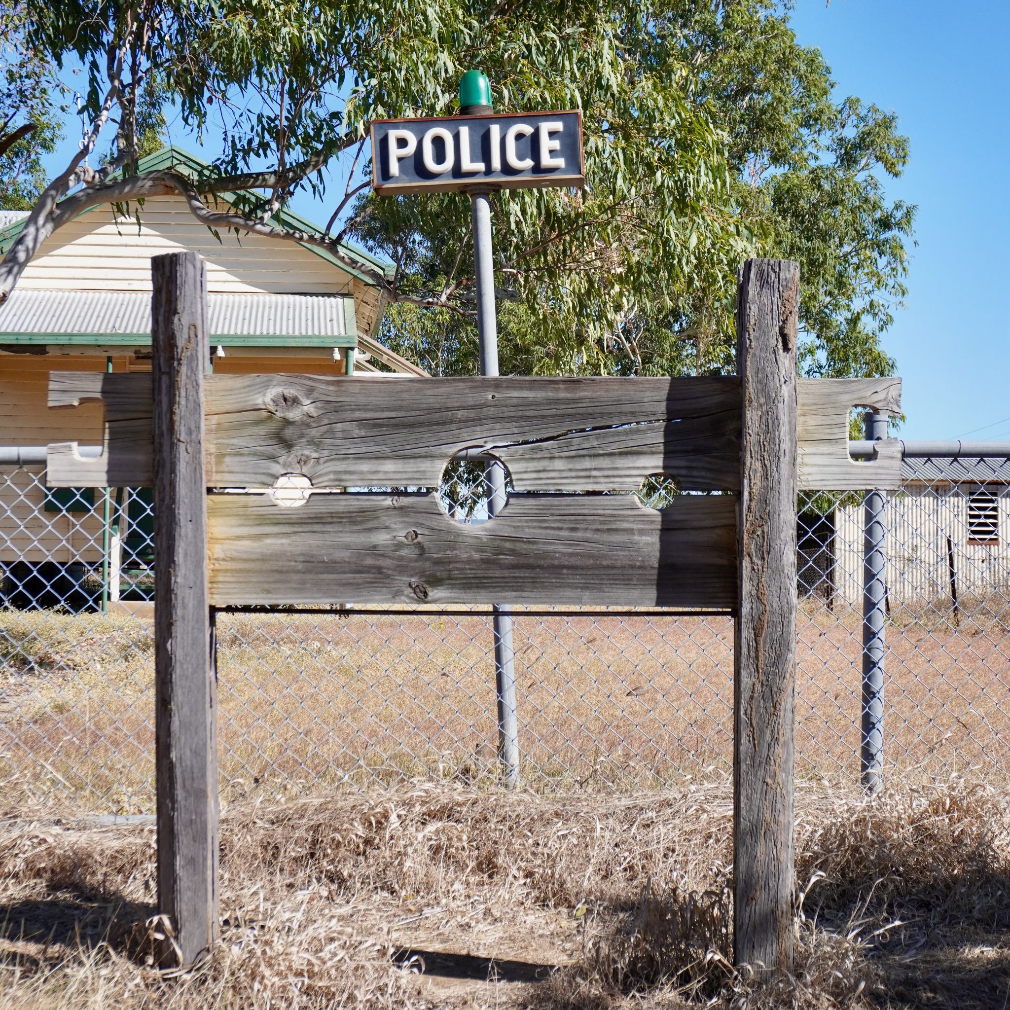 A wooden pillory in front of a police station in Queensland's outback.