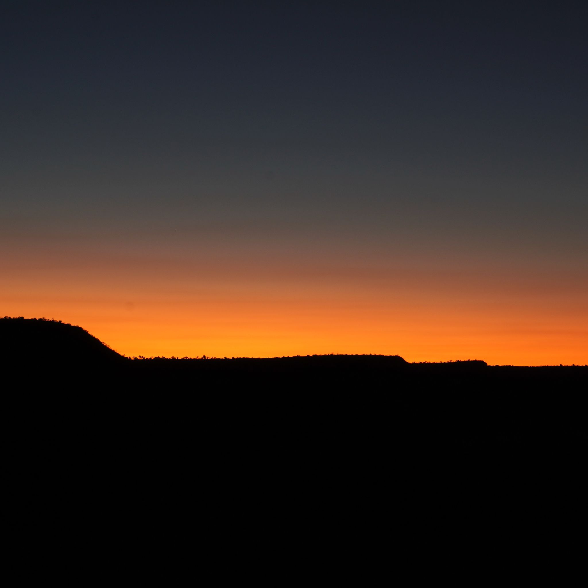 A picture of the sky during sunset, with a gradient of orange.